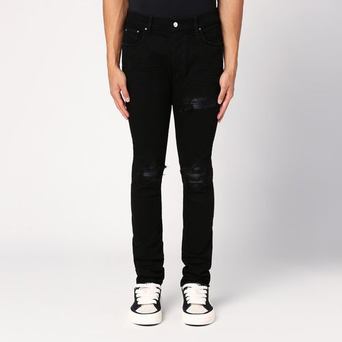 Jeans skinny nero con strappi - AMIRI - Modalova