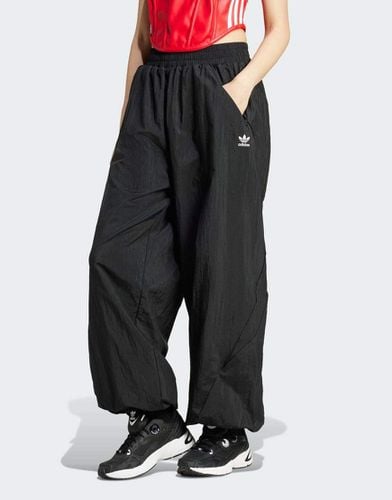 Pantaloni neri a fondo ampio - adidas Originals - Modalova