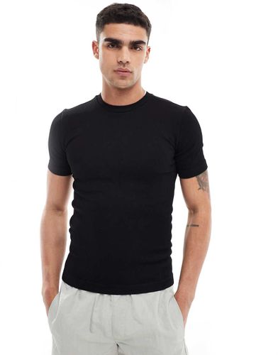 Icon - T-shirt da allenamento attillata nera a coste senza cuciture - ASOS - Modalova