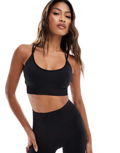 Reggiseno sportivo a sostegno medio senza cuciture - ASOS - Modalova