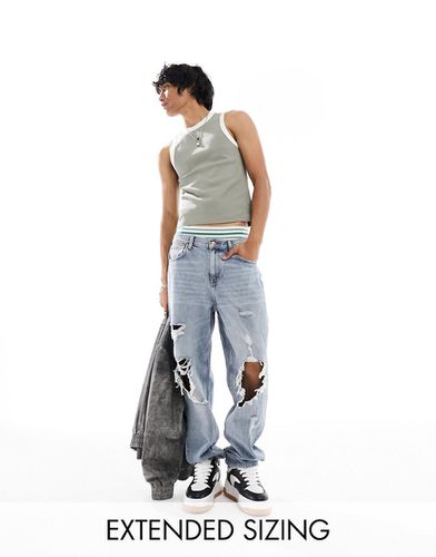 Jeans ampi lavaggio chiaro con strappi vistosi - ASOS DESIGN - Modalova