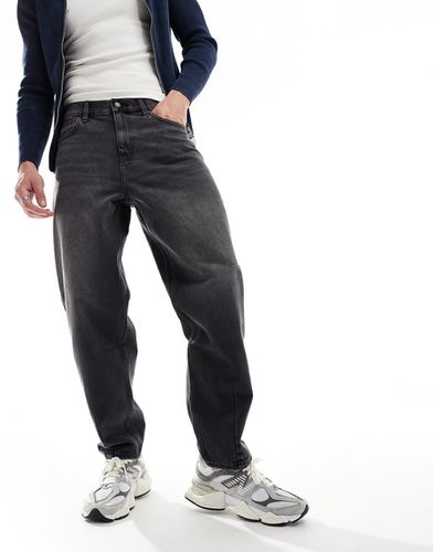 Jeans ampi slavato con baffature - ASOS DESIGN - Modalova
