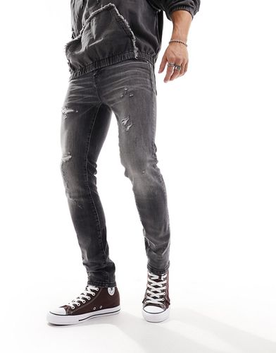Jeans skinny slavato vintage con abrasioni - ASOS DESIGN - Modalova