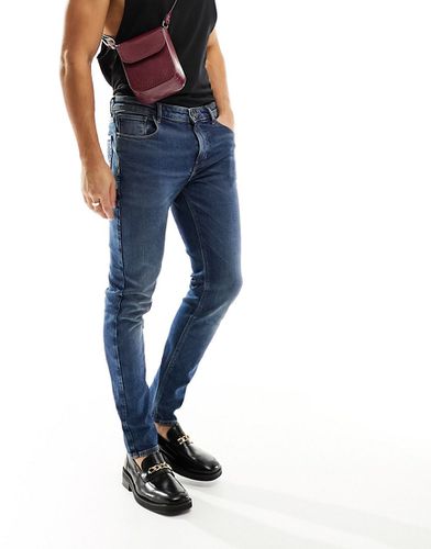 Jeans skinny lavaggio scuro - ASOS DESIGN - Modalova