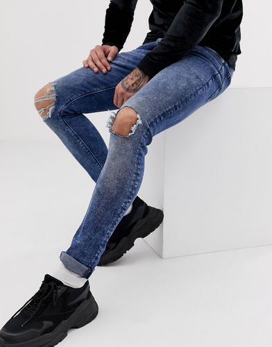 Jeans super skinny lavaggio acido con ginocchia strappate - ASOS DESIGN - Modalova