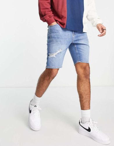 Pantaloncini di jeans skinny lunghezza normale lavaggio medio con strappi - ASOS DESIGN - Modalova