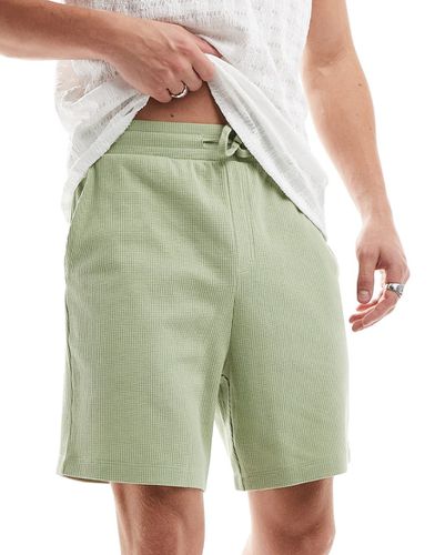 Pantaloncini slim in piqué verdi - ASOS DESIGN - Modalova