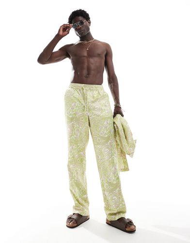 Pantaloni a fondo ampio in raso con elastico in vita e stampa paisley in coordinato - ASOS DESIGN - Modalova