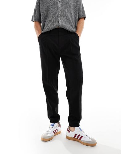 Pantaloni eleganti affusolati neri con fondo stile joggers - ASOS DESIGN - Modalova