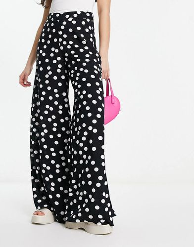 Pantaloni palazzo neri con stampa a pois - ASOS DESIGN - Modalova