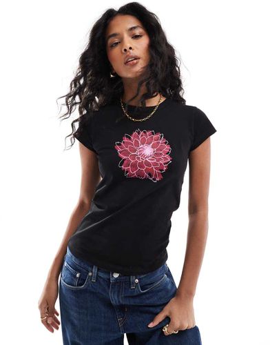 T-shirt attillata nera con grafica floreale - ASOS DESIGN - Modalova