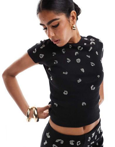 T-shirt corta nera a coste con motivo leopardato con paillettes - ASOS DESIGN - Modalova