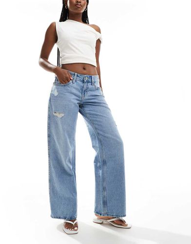 Jeans ampi a vita bassa medio con strappi - Hollister - Modalova