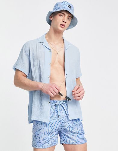 Cappello da pescatore e pantaloncini da bagno con stampa astratta in coordinato - Native Youth - Modalova