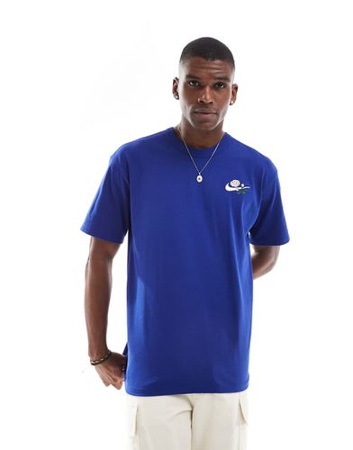 Nike - T-shirt blu con logo a fiori - Nike - Modalova