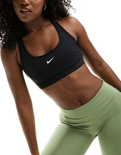 Reggiseno sportivo a sostegno leggero con logo Nike - Nike Training - Modalova