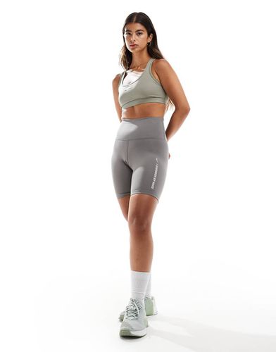 Reggiseno sportivo kaki a supporto leggero con logo - Nike Training - Modalova