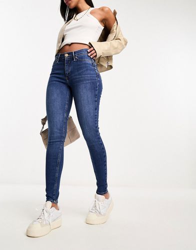 Molly - Jeans skinny a vita medio alta modellanti lavaggio medio - River Island - Modalova