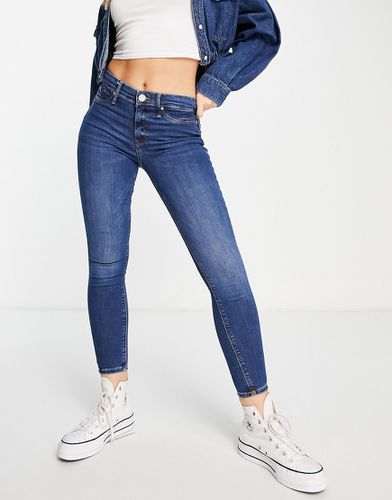 Molly - Jeans skinny a vita medio alta modellanti sui glutei scuro - River Island - Modalova