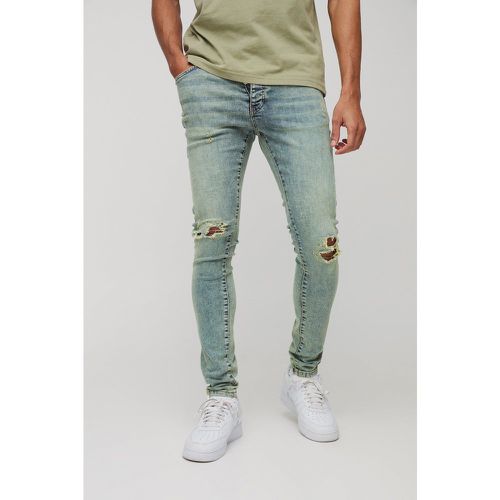 Jeans slavati Super Skinny Fit con strappi all over - boohoo - Modalova