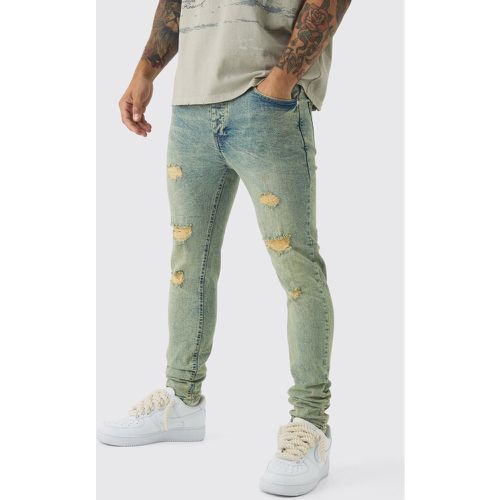 Jeans Skinny Fit Stretch in lavaggio sporco con strappi & rattoppi - boohoo - Modalova