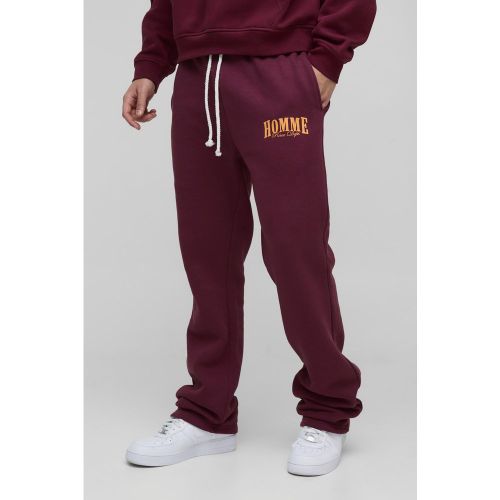 Pantaloni tuta a zampa Slim Fit Homme con pieghe sul fondo - boohoo - Modalova