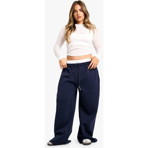 Pantaloni tuta Petite a gamba ampia con laccetti - boohoo - Modalova