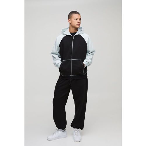 Tuta sportiva oversize Man a blocchi di colore con zip e cappuccio - boohoo - Modalova