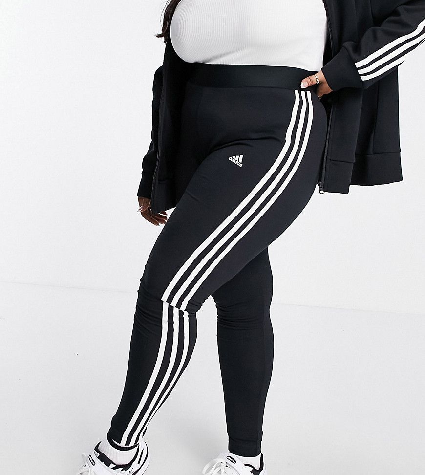 Adidas Plus - Sportswear Essential - Leggings neri con 3 strisce - adidas performance - Modalova