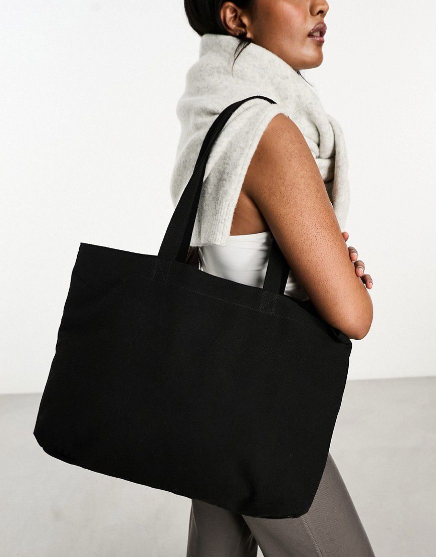 Borsa shopping nera in tela con tasca per laptop - ASOS DESIGN - Modalova