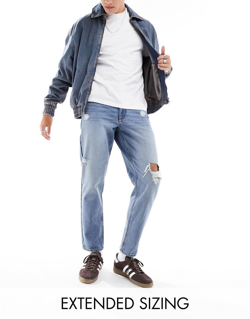 Jeans classici rigidi lavaggio medio con strappi - ASOS DESIGN - Modalova